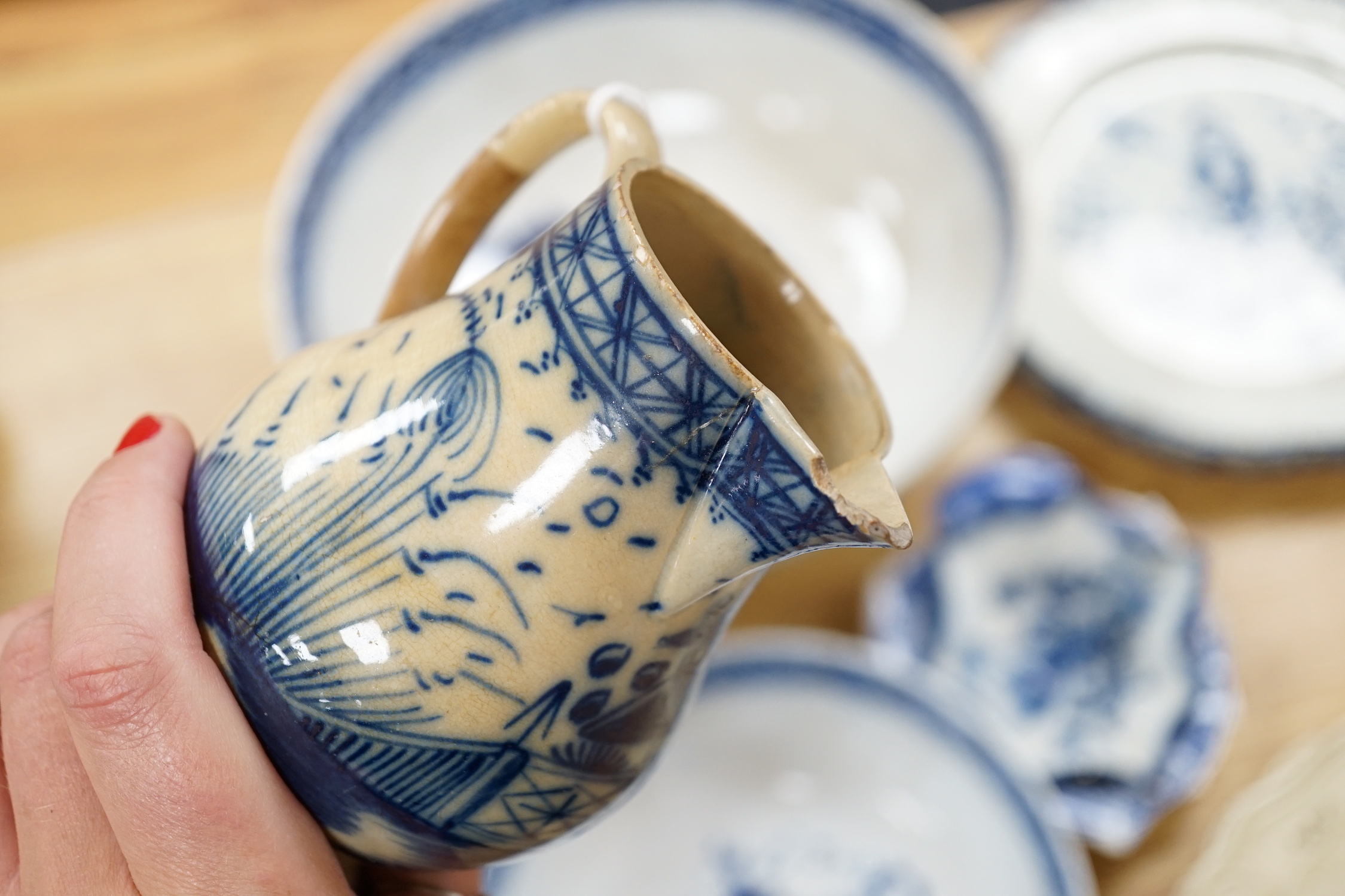 A collection of late 18th/early 19th century pearlware and creamware including three black transfer printed creamware plates, c.1780, blue and white bowls, plates, dishes and jug, the largest 27cm in diameter